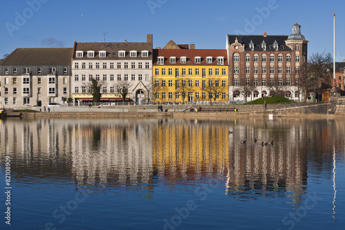 Row of Colorful Buildings on Sunny Day Reflected in Water