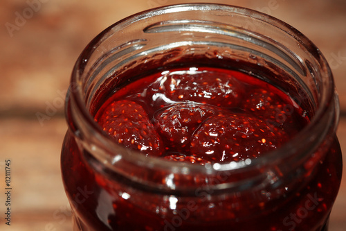 Jar of strawberry jam close up
