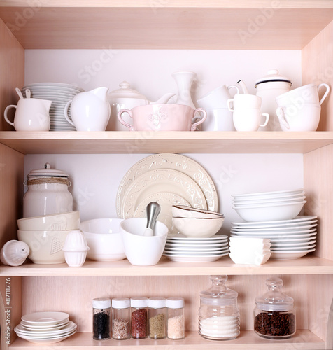 Kitchen utensils and tableware on shelves