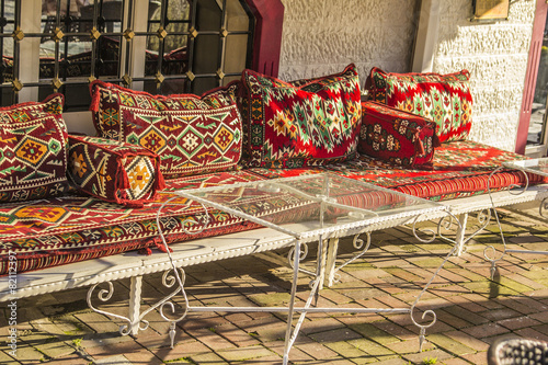Canvas Print Eastern Divan with cushions and a glass table in a cafe