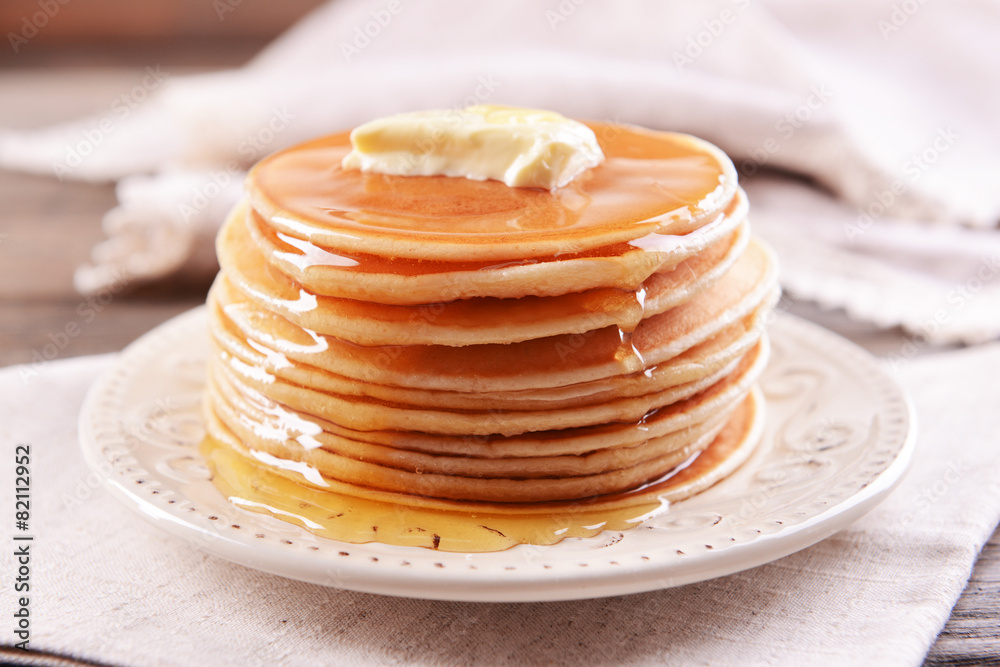 Delicious pancakes with honey on plate on table close-up Delicious pancakes with honey on plate on table close-up