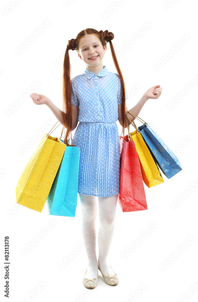 Beautiful little girl with shopping bags, isolated on white