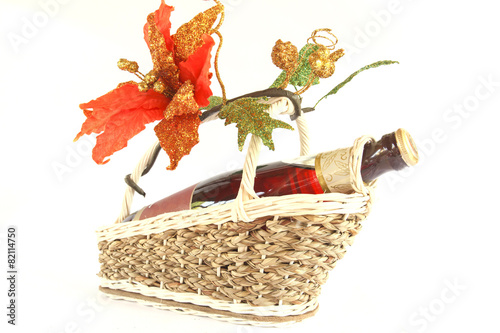 wine bottle with blank label on present basket with fake flower