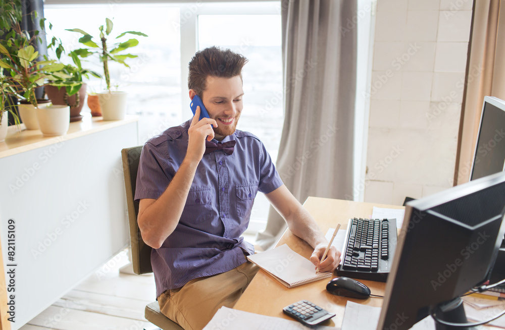 happy creative male worker calling on smarphone