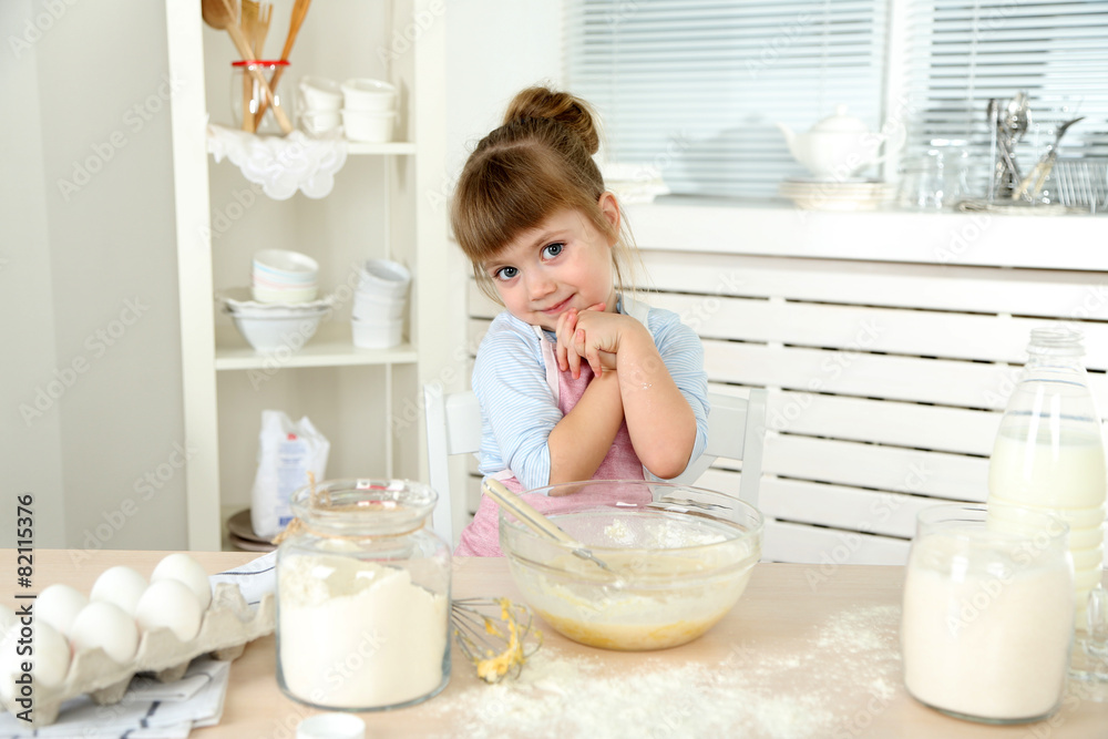 Little girl preparing cookies in kitchen at home Little girl preparing cookies in kitchen at home