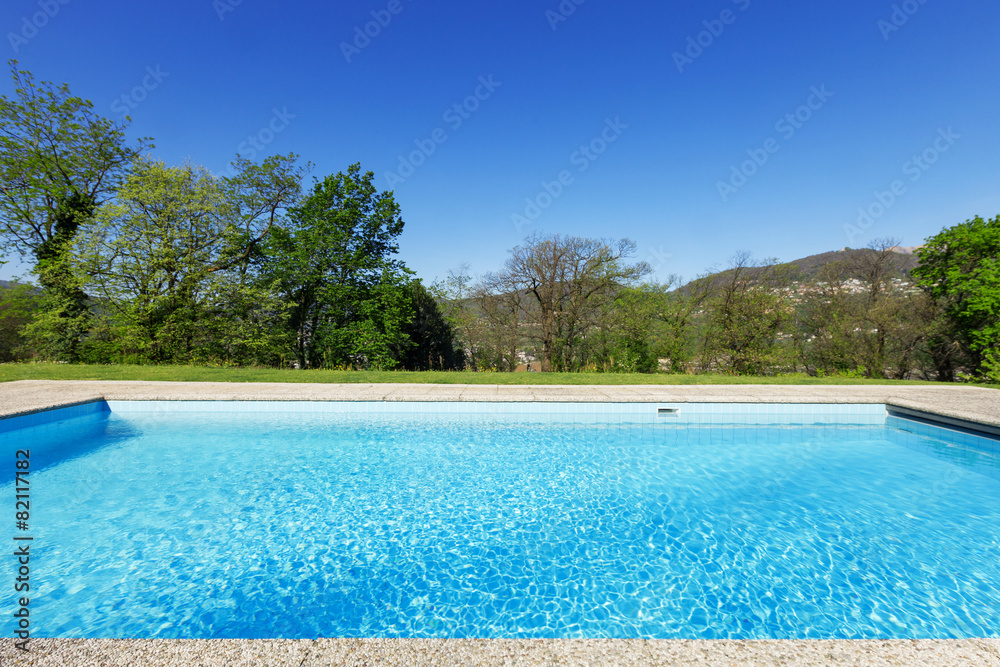 Outside of modern house in summer, swimming pool