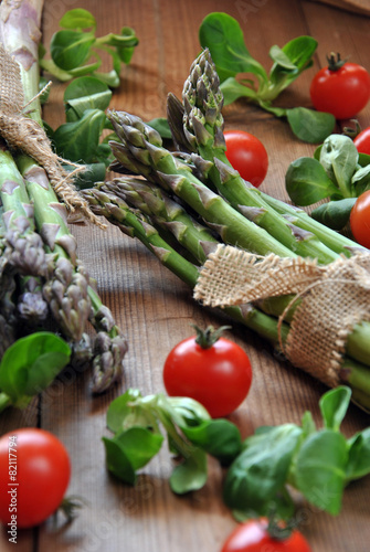 organic asparagus on wooden table accompanied