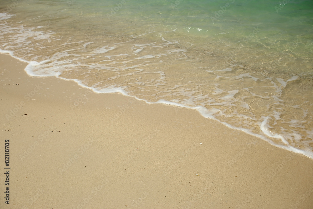 Wave of the sea on sandy beach.