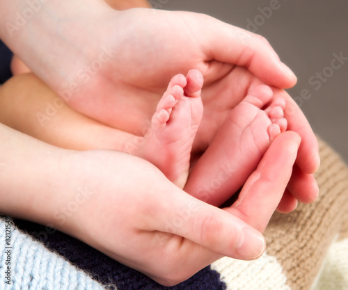 leg newborn little baby in the mother's hands