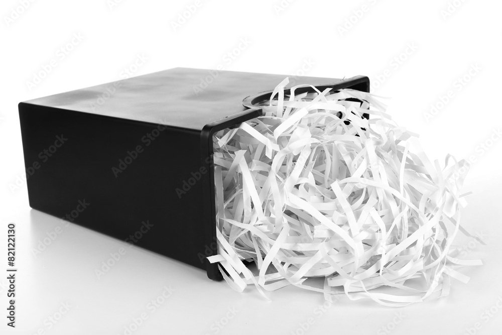 Fototapeta premium Strips of destroyed paper from shredder in trash can isolated