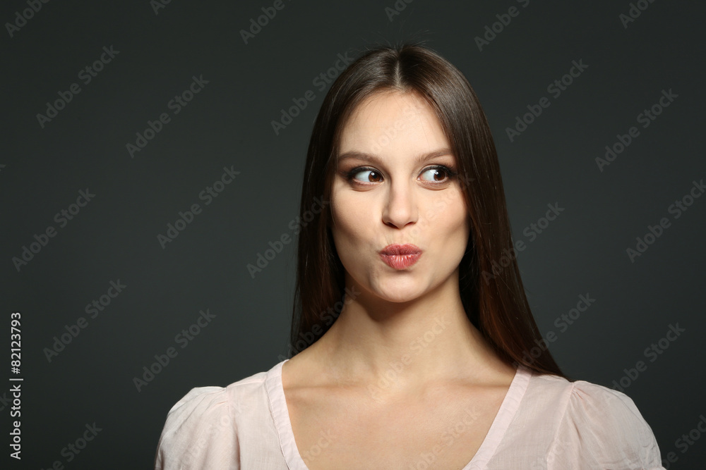 Portrait of beautiful young woman on dark background Portrait of beautiful young woman on dark background