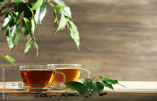 Cups of green tea on table on wooden background