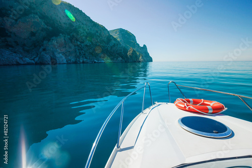 Private boat floats near mountains. Traveling on yacht