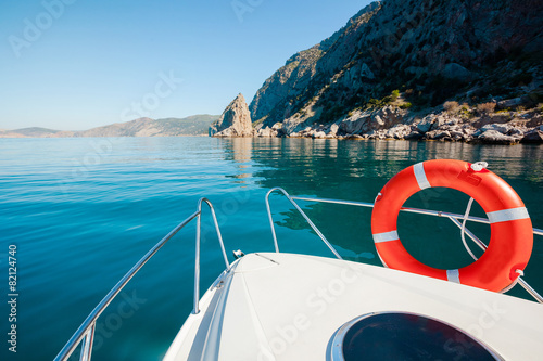 Boat floats near mountains. Luxury Lifestyle. Traveling on yacht
