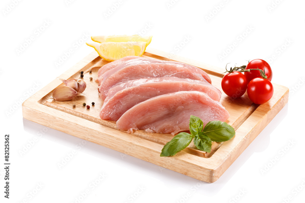 Raw chicken breasts on cutting board on white background Raw chicken breasts on cutting board on white background