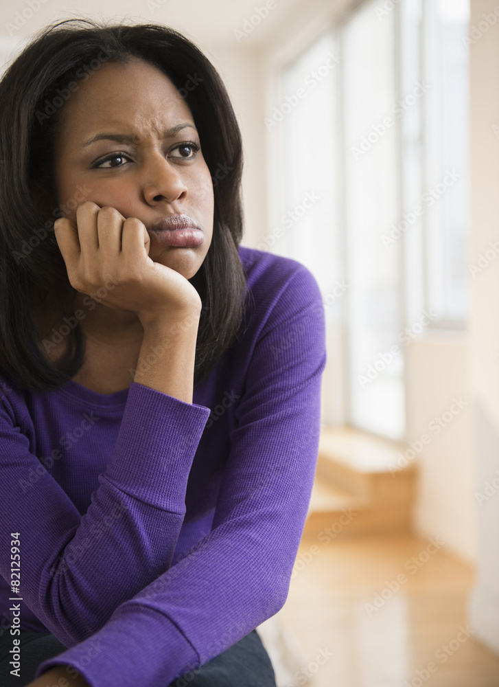 Anxious African American woman frowning Anxious African American woman frowning