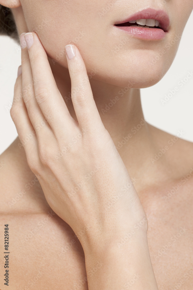 Nude Caucasian woman touching her jaw Nude Caucasian woman touching her jaw