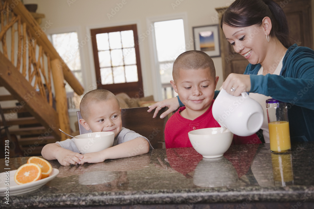 Hispanic mother and sons eating breakfast Hispanic mother and sons eating breakfast