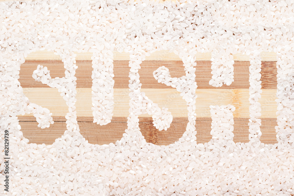 Rice grain. Word sushi written on wooden cutting board Rice grain. Word sushi written on wooden cutting board