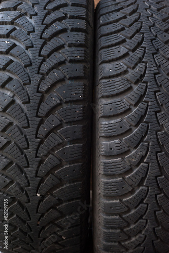 Car tires in a row on a shelf tire