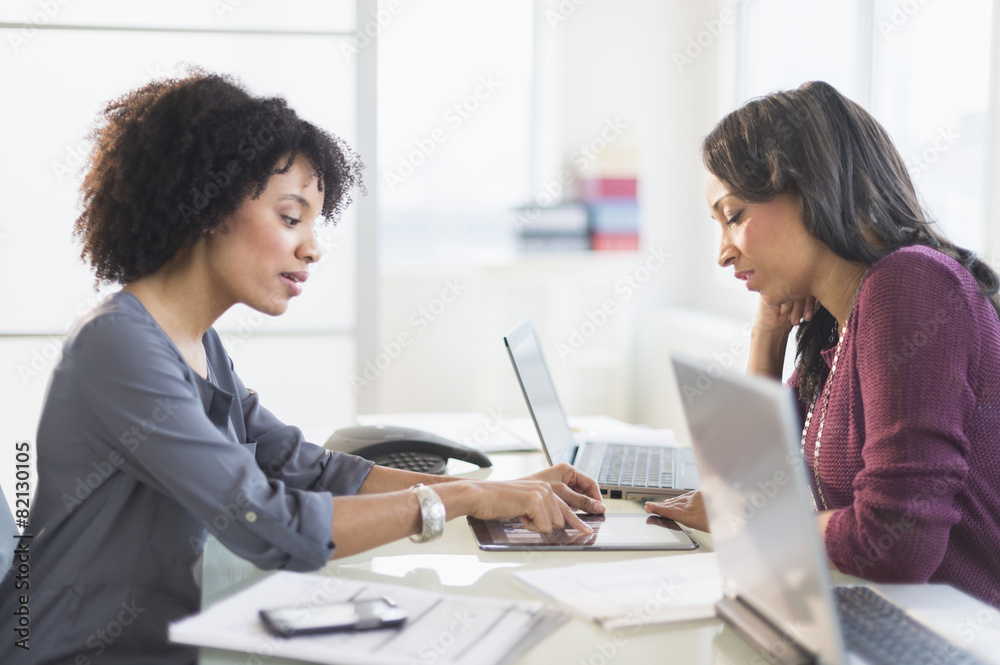 African American businesswomen talking in meeting African American businesswomen talking in meeting