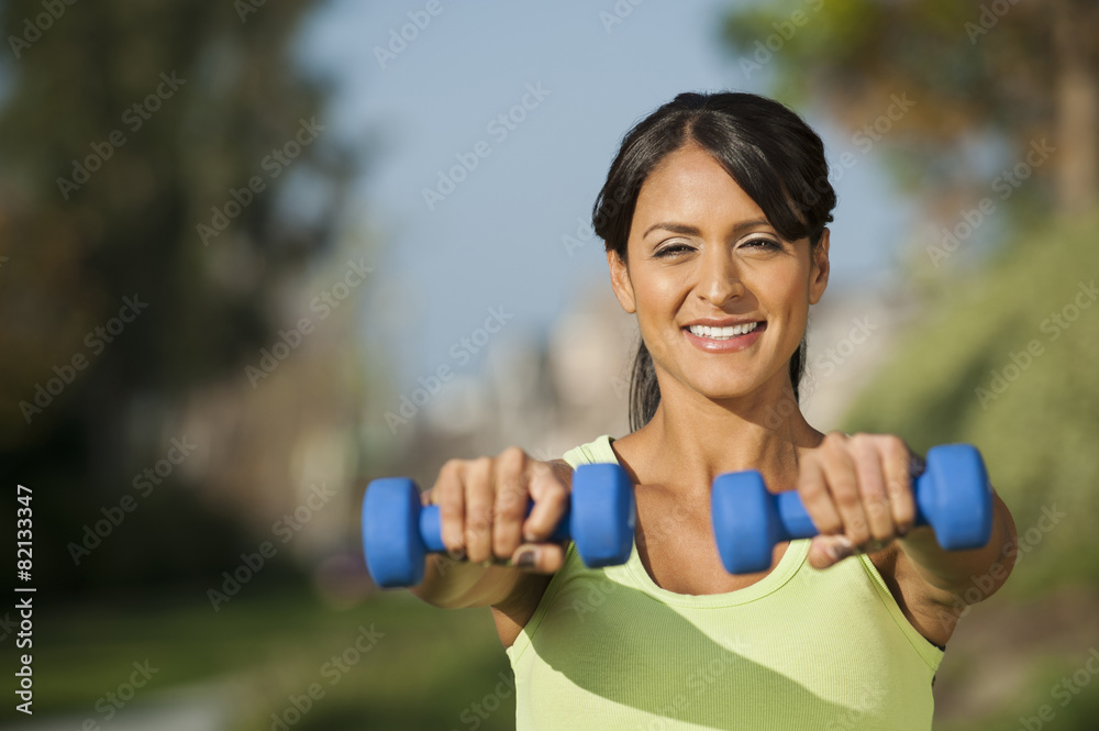 Hispanic woman lifting weights outdoors Hispanic woman lifting weights outdoors