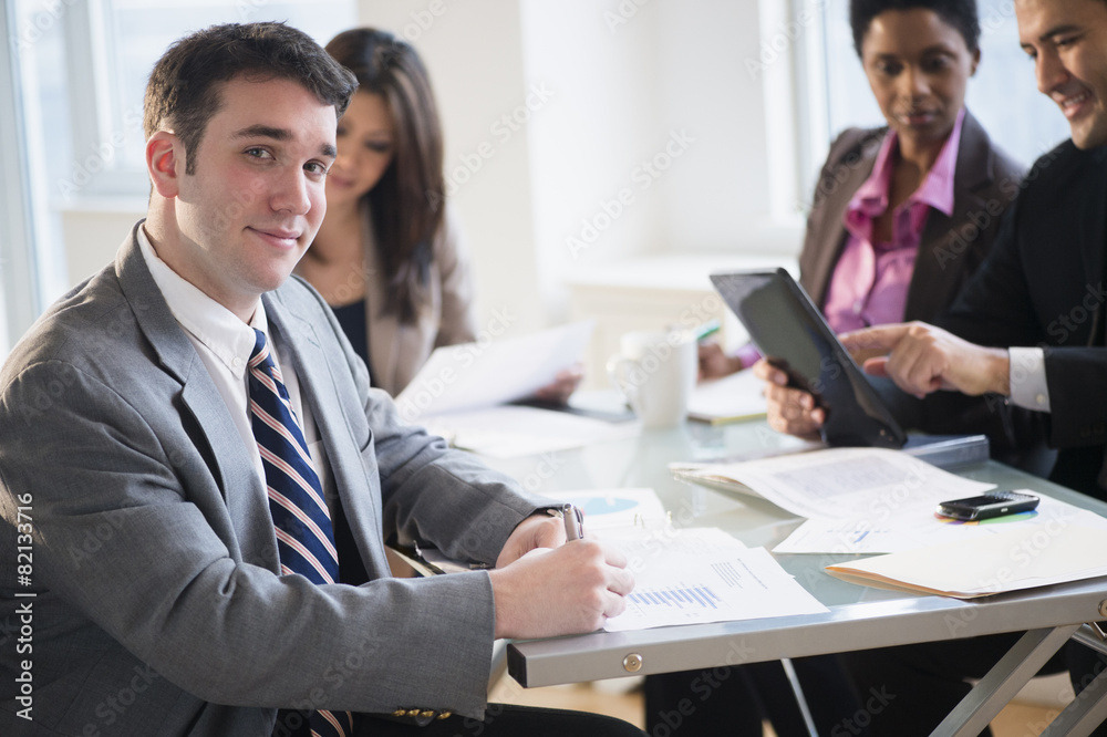 Businessman smiling in meeting Businessman smiling in meeting
