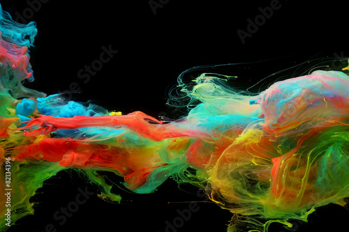 Clouds of bright colorful ink mixing in water