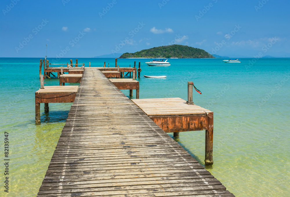 Old wooden jetty on exotic beach island