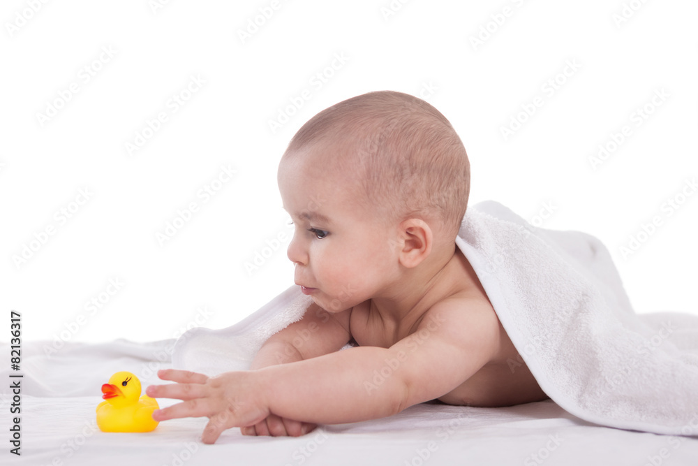 Little cute baby playing with yellow duck after shower, isolated Little cute baby playing with yellow duck after shower, isolated