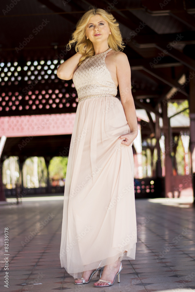 Blond woman in evening gown posing Blond woman in evening gown posing