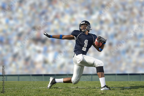 African American football player poised on field photo