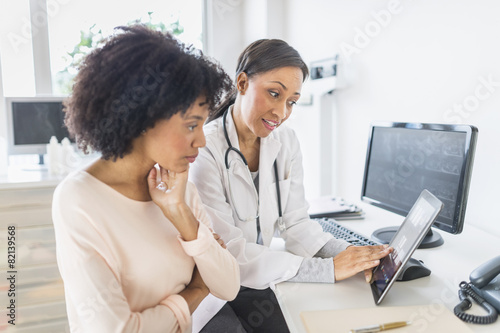 African American doctor and patient talking in office photo