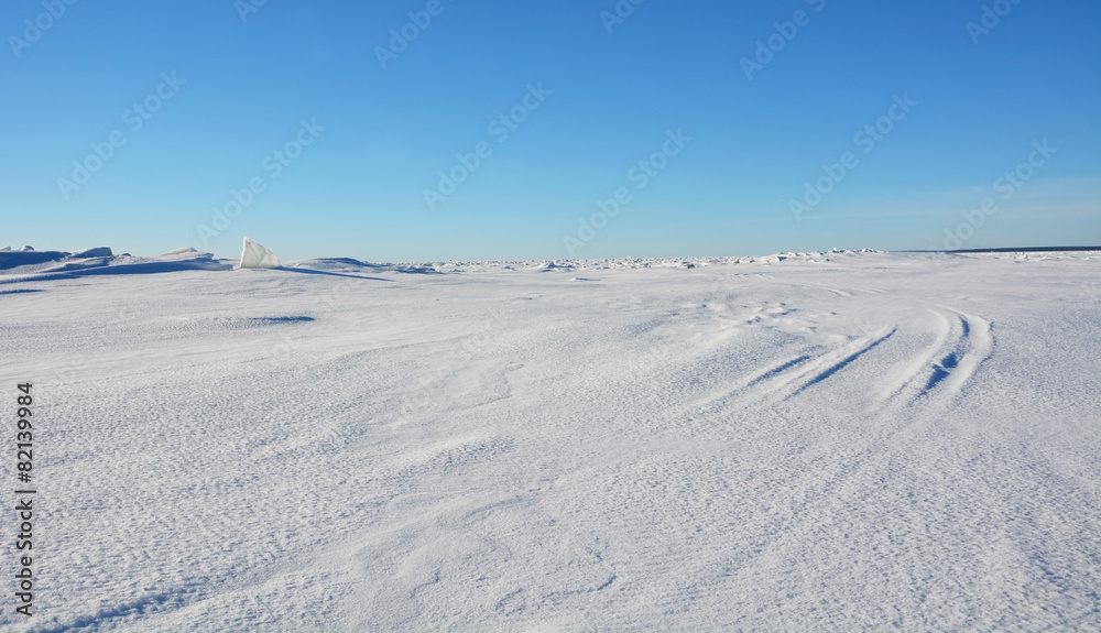 Frozen sea landscape at sunny day with sky tracks Frozen sea landscape at sunny day with sky tracks