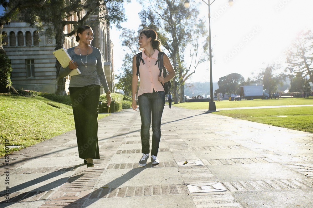Professor and student walking on campus Professor and student walking on campus