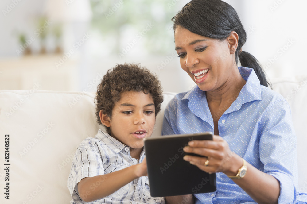 Mother and son using digital tablet Mother and son using digital tablet
