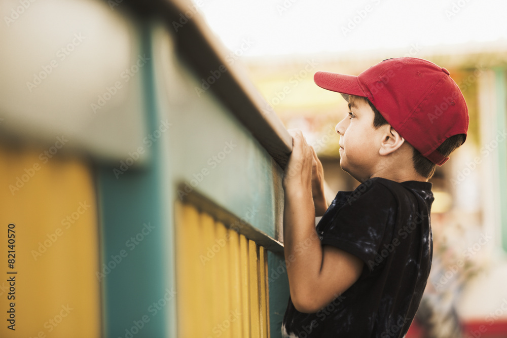 Mixed race boy climbing on banister Mixed race boy climbing on banister