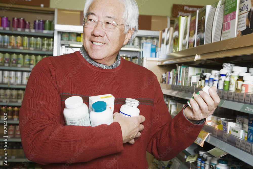 Senior Asian man shopping for natural medicine Senior Asian man shopping for natural medicine