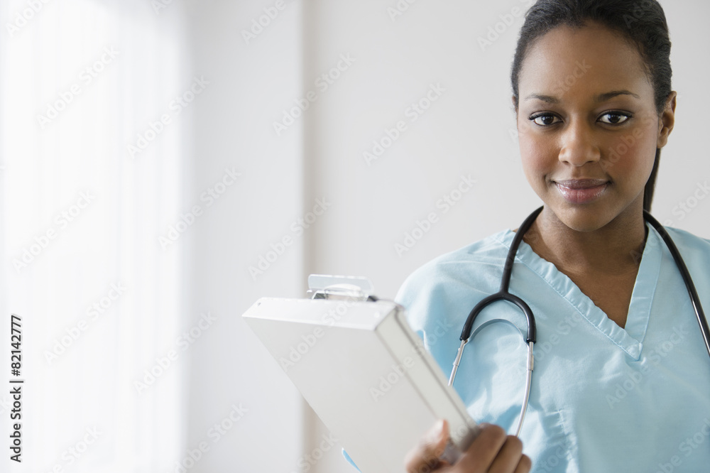 African American nurse holding clipboard African American nurse holding clipboard