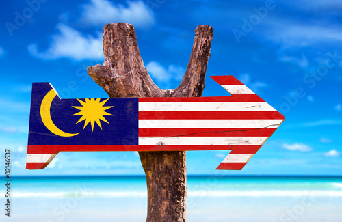 Malaysia Flag wooden sign with beach background photo