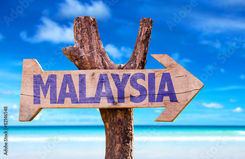 Malaysia wooden sign with beach background photo