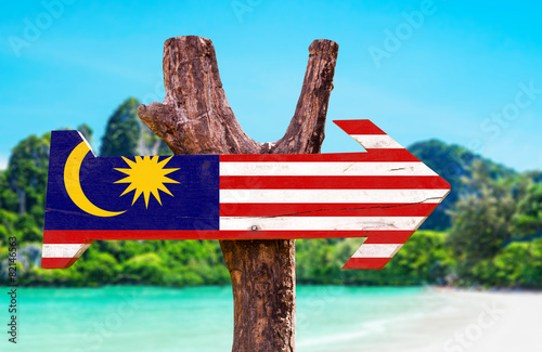 Malaysia Flag wooden sign with beach background photo