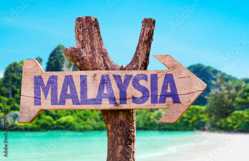 Malaysia wooden sign with beach background photo