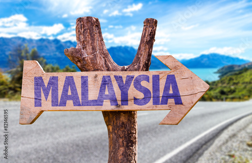 Malaysia wooden sign with road background photo