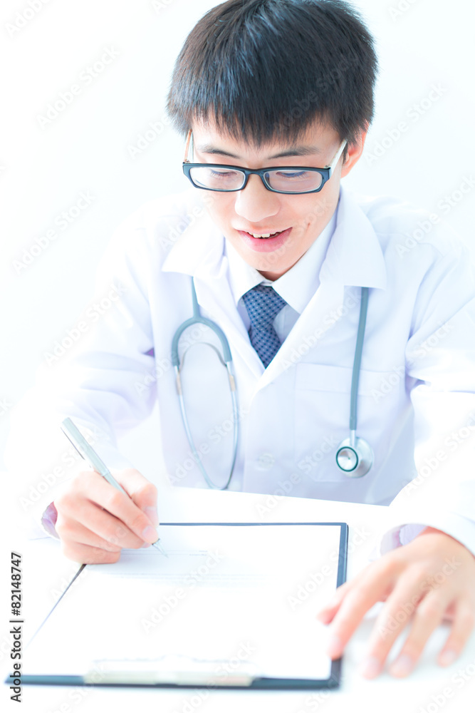 Close-up Of Male Doctor Filling The Medical Form Close-up Of Male Doctor Filling The Medical Form