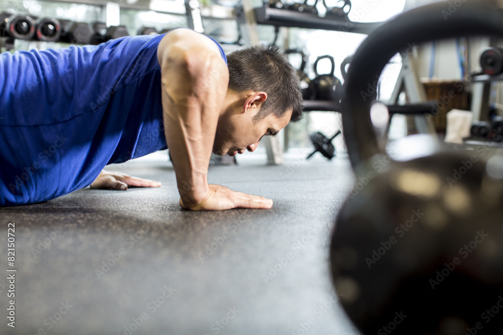 Pacific Islander man working out in gym