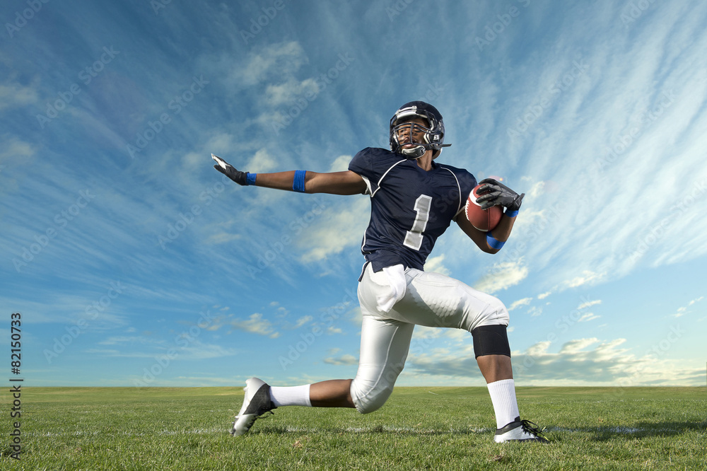 African American football player poised on field African American football player poised on field