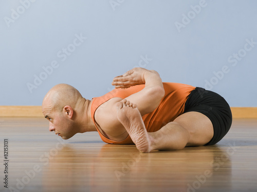 Hispanic man practicing yoga photo