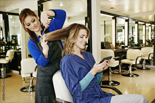 Woman having hair cut in salon photo