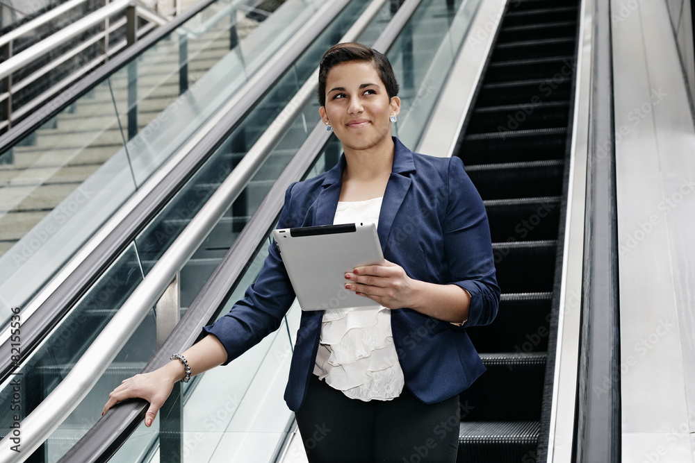 Hispanic businesswoman using tablet computer Hispanic businesswoman using tablet computer